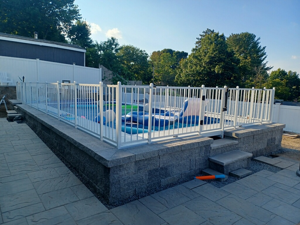 Pool with paver deck and clean landscaping, North Shore MA